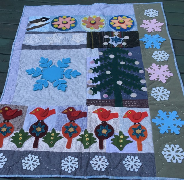 Ann P's adaption of Sue Spargo's Crimson Tide Christmas Quilt, changed to be a January quilt.